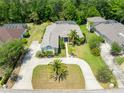 Expansive aerial view of this meticulously maintained property, showcasing lush lawns and mature trees at 69 Coquina Ridge Way, Ormond Beach, FL 32174