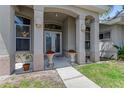 Welcoming front entrance with elegant columns and decorative accents at 69 Coquina Ridge Way, Ormond Beach, FL 32174