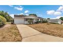 Inviting one-story home with an attached garage and well-kept front yard at 8720 Sw 108Th Ln, Ocala, FL 34481