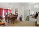 Inviting dining room featuring a large table, chandelier, and arched entryway to other rooms at 1305 Rebecca Dr, Haines City, FL 33844