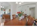 Inviting dining room featuring a large table, chandelier, and arched entryway to other rooms at 1305 Rebecca Dr, Haines City, FL 33844