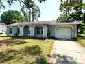 Single story home with a front yard, archway, and attached one-car garage at 1355 Dexter E Dr, Port Orange, FL 32129