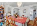 Dining room featuring a decorative chandelier, archways, and views into other living spaces at 1956 Southern Dunes Blvd, Haines City, FL 33844
