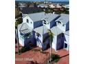 An aerial view of a three-story colorful home with multiple balconies and ample parking at 3000 Ocean Shore Blvd # 150, Ormond Beach, FL 32176