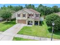 Beautiful two-story home with brown shutters, a large lawn and a cozy front porch at 5 Cantilever Ct, Ormond Beach, FL 32174