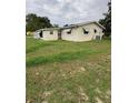 Exterior shot showcasing the side of the house and a spacious yard at 9393 Sw 102Nd Pl, Ocala, FL 34481