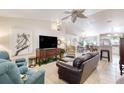 Bright living room with tile floors, ceiling fan, and open concept design into kitchen at 1465 Admrial Nimitz Ave, Daytona Beach, FL 32124