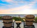 Oceanfront lounge area with two Adirondack chairs offer scenic views of the water at 1504 N Atlantic Ave, Daytona Beach, FL 32118