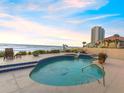 Relaxing pool area offering ocean views, adjacent to a building and lush landscaping at 1504 N Atlantic Ave, Daytona Beach, FL 32118