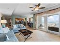 Comfortable living room with ocean views, open to kitchen, tile floors, and sliding glass door to balcony at 2071 S Atlantic Ave # 1005, Daytona Beach Shores, FL 32118