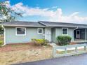 Charming single-story home with light green siding, covered parking, and manicured front bushes at 244 Oakleigh Dr # 200, Deland, FL 32724