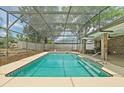 The screened-in pool offers refreshing turquoise waters, steps, and a large patio for enjoyment and entertainment at 2468 Scottville Ave, Deltona, FL 32725
