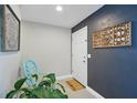 Welcoming entryway with a decorative chair, plant, and a custom wall accent at 290 Greenwood Cir, Ormond Beach, FL 32174