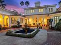 Home's exterior courtyard with archways, fountain, plants, and furniture for a peaceful and relaxing area at 37918 N County Road 44A, Eustis, FL 32736