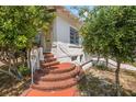 Home's unique brick steps, leading to the front entrance, with mature trees at 401 N Oleander Ave, Daytona Beach, FL 32118