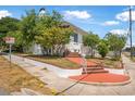 Charming two-story home with mature trees, offering a serene curb appeal at 401 N Oleander Ave, Daytona Beach, FL 32118