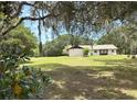 Charming house with mature trees and expansive lawn at 486 S Us Highway 1, Oak Hill, FL 32759