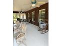 Spacious screened porch with ceiling fans, chairs, a table and windows offering pleasant views at 486 S Us Highway 1, Oak Hill, FL 32759