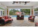 Relaxing covered patio with outdoor furniture overlooking a sparkling pool and backyard at 5865 Ross Creek Rd, Lakeland, FL 33810