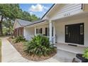Inviting front porch with black shutters and lush landscaping at 5865 Ross Creek Rd, Lakeland, FL 33810