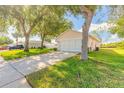 Single story home showcasing a spacious driveway with room for multiple vehicles at 613 Clairmont Ln, South Daytona, FL 32119
