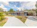 Beautiful home featuring a convenient carport, solar panels, and a curved walkway to the front door at 991 Dawson Dr, Deltona, FL 32725