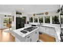 Open kitchen with large center island, white cabinets, and modern appliances at 1 Crooked Bridge Way, Ormond Beach, FL 32174