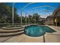 Gorgeous screened-in pool with jacuzzi and stunning backyard view at 1766 Roscoe Turner Trl, Port Orange, FL 32128
