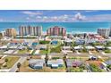 Expansive aerial view of oceanfront condos, tennis courts, and homes in a sunny coastal setting at 3828 S Atlantic Ave, Daytona Beach, FL 32118