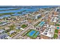 An aerial view of the community with tennis courts, various styles of homes and a view of the water at 3828 S Atlantic Ave, Daytona Beach, FL 32118