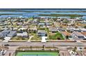 An aerial view shows the house with an extra-long driveway in a neighborhood near a body of water at 3828 S Atlantic Ave, Daytona Beach, FL 32118