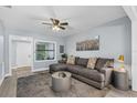 Comfortable living room showcasing a large sectional sofa, ceiling fan, and stylish accents at 603 W Miles St, Deland, FL 32720