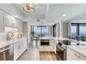 Modern kitchen with white cabinets, stainless steel appliances, and a stylish island featuring views of the intracoastal at 1239 Ocean Shore Blvd # 11D, Ormond Beach, FL 32176