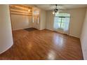 Bright living room featuring wood floors, large windows, and high ceilings with decorative lighting at 16 Hunt Master Ct, Ormond Beach, FL 32174
