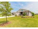 Beautiful single-story home with lush green lawn, mature trees, and three-car garage in a lovely neighborhood at 2840 Monaghan Dr, Ormond Beach, FL 32174