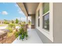 Inviting front porch with decorative brick pillars, potted plants, and view of manicured landscaping at 2840 Monaghan Dr, Ormond Beach, FL 32174