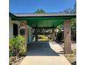 Attached carport features brick columns and green painted ceiling, offering convenient covered parking and curb appeal at 741 Ellen St, Daytona Beach, FL 32114