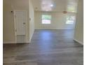 Spacious living room featuring sleek, modern gray flooring and natural light from the windows at 741 Ellen St, Daytona Beach, FL 32114