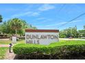 Entrance to Dunlawton Hills featuring mature trees and landscaping at 915 Stonybrook Cir, Port Orange, FL 32127