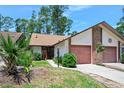 Charming home featuring a two-car garage and well-manicured front yard at 915 Stonybrook Cir, Port Orange, FL 32127