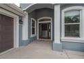 The columned entry features a decorative glass door and well-maintained concrete landing at 3345 Tesoro Cir, New Smyrna Beach, FL 32168