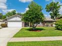 Charming single-story home with a well-maintained lawn and attached garage in a desirable neighborhood at 934 Tall Pine Dr, Port Orange, FL 32127