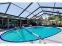 Backyard pool with screened-in lanai, pool furniture, and well-maintained patio space at 934 Tall Pine Dr, Port Orange, FL 32127