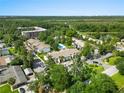 Aerial view of the property with lush landscaping and a community pool at 1 Tomoka Oaks Blvd # 135, Ormond Beach, FL 32174