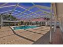 Fully enclosed backyard pool and jacuzzi featuring brick pavers, tropical vegetation, and lots of space at 136 Reef Rd, South Daytona, FL 32119