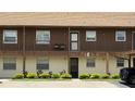 Close up exterior of unit featuring a private balcony, well kept landscaping, and covered walkway at 1640 Juno Trl # 202E, Astor, FL 32102