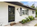 The front door of the home, flanked by plants and a colorful doormat, is inviting at 2101 Almond St, Orange City, FL 32763