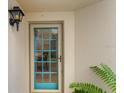 Charming front door with decorative glass and a stylish light fixture creating a welcoming entrance at 2934 Oceans Trce, Daytona Beach Shores, FL 32118