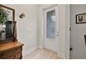 Bright entryway featuring wood-look tile floors, and a door with decorative glass at 3029 Adrian Dr, Ormond Beach, FL 32174