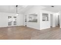 Spacious living room leading to the kitchen and a private sunroom through French doors at 807 Scrub Oak St, South Daytona, FL 32119
